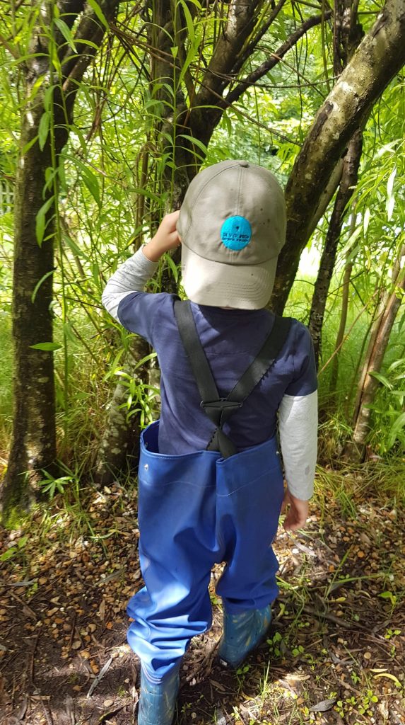 Young child playing the woods